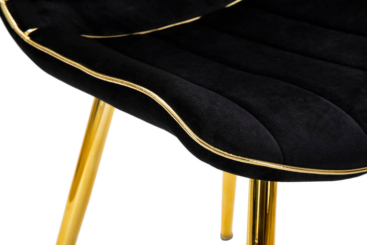 Schwarzer gepolsterter Stuhl mit goldenen Metallbeinen