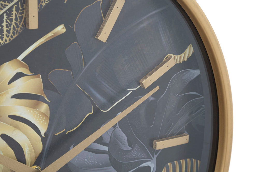 Goldene und graue Wanduhr mit tropischem Blattmuster