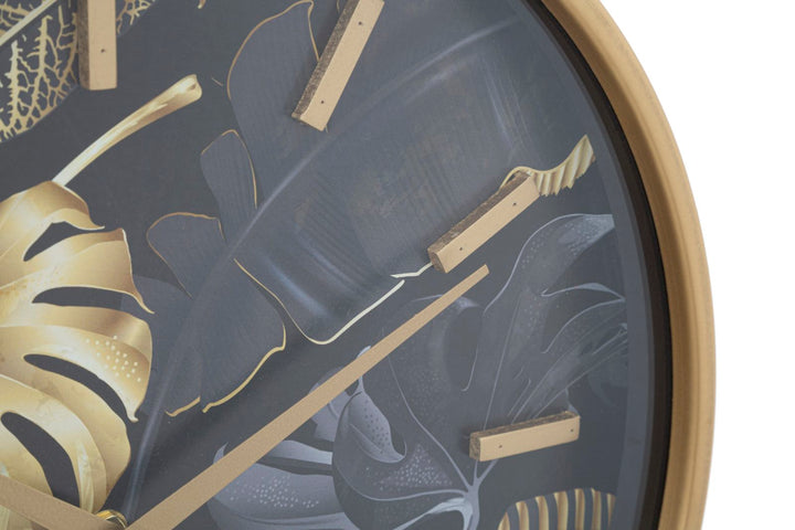 Goldene und graue Wanduhr mit tropischem Blattmuster