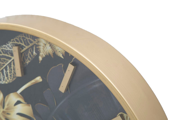 Goldene und graue Wanduhr mit tropischem Blattmuster