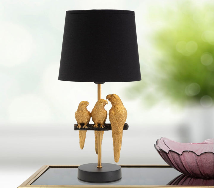 Schwarze Tischlampe mit goldenen Papageien